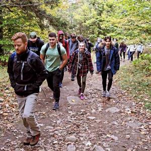 Students hiking through the woods