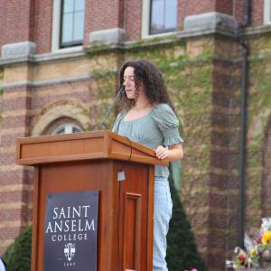 Student speaking at a memorial in front of Alumni Hall