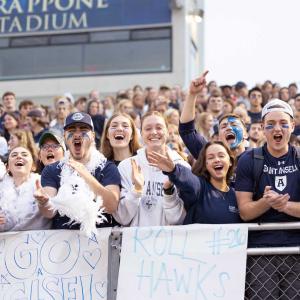 Students cheering in the stands of Grappone Stadium