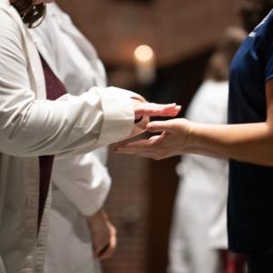 Two hands being blessed