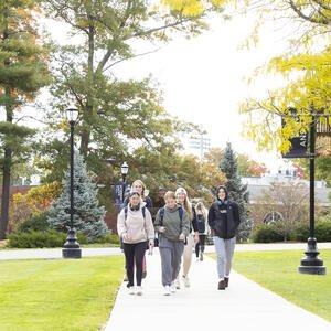 Students walking on a college campus in the fall
