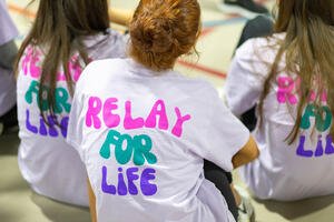 Women sitting with t-shirt backs that say "Relay for Life"