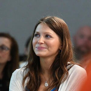 Candid photo of a young woman sitting at a table