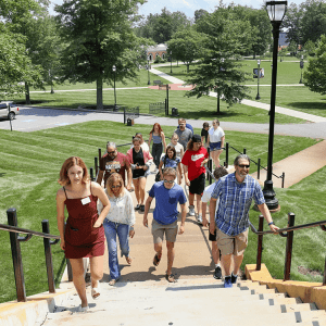 students walking up the steps from the lower quad