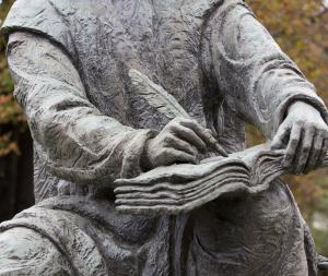 closeup of statue of St. Benedict, focusing on hand writing in book