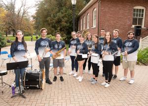 members of the pep band practice outside