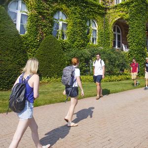 students walking in front of iconic Alumni Hall