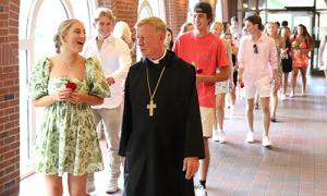 Abbot Mark Cooper, O.S.B. ’71 walks with newly arrived members of the Class of 2026
