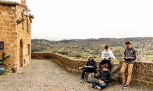Students sitting along a wall in Tuscania