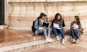 Students grab a seat to regroup and review outside of the Italian cathedral, the Duomo.