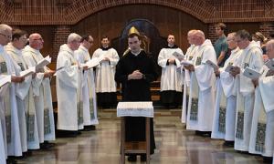 Br. Basil professes simple vows while surrounded by other members of the monastery