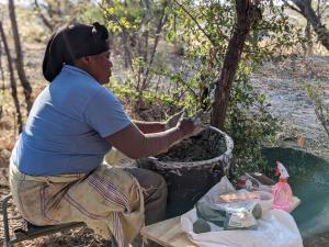A Moela Safari artisan helping process wild clay for the project along the Boteti River in the Makgadikgadi.