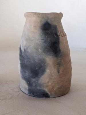 A pit fired vase, partially blackened 