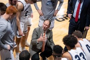 Keith Dickson speaking to the Saint Anselm Men's Basketball team during a game against Saint Mike's