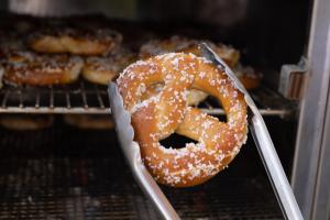 A pretzel held by tongs served during PYCO