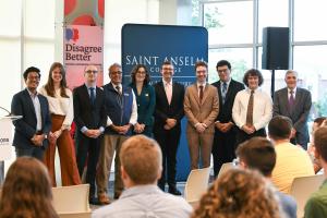 President Favazza standing with student ambassadors at the NHIOP event