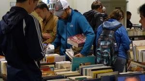 Image of visitors browsing books at the 2014 book sale.
