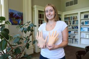 Margaret Malloy '23 holding two rubber hands to study an illusion