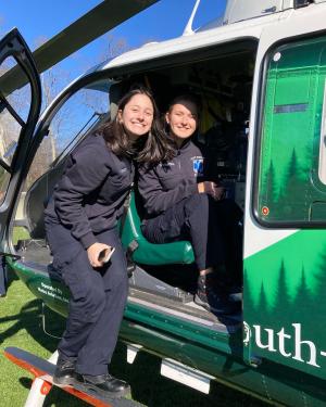 Student EMS workers posing in a medical helicopter that visited campus