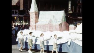 a film still of Ste-Marie Church parade float