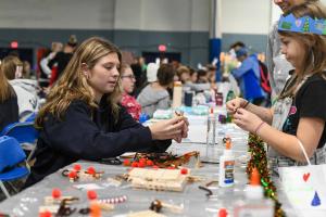Student volunteers participated in the Holiday Fair by making crafts with the local children