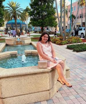 Carly Zinko sitting by a fountain