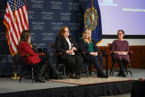 Courtney Tanner ’11, Senator Soucy, and Dr. Christine Gustafson watch on as Senator Carson engages the crowd.