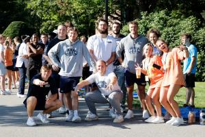 Saint Anselm students pose for a photo in between helping freshman move in