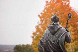 Statue of Saint Benedict facing out on Alumni Quad