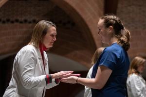 Nurse having her hands blessed at the ceremony