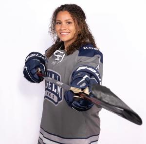Sydney Merritt posing with a hockey stick