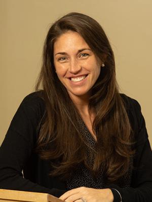 Kaitlyn Clarke '09 sits at a podium