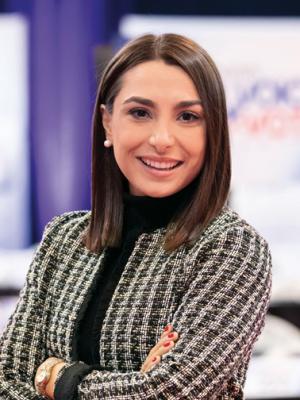 Kelsey Walsh stands in the spin room for the Democratic Debate