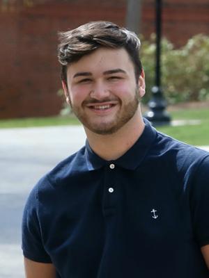 Guy Parenteau '23 stands outside Davison Hall