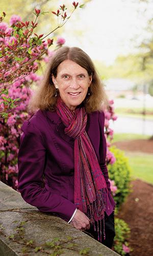 Professor Emerita Katherine Hoffman posing in the grotto