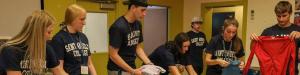 Students sort clothes for charity on their day of service