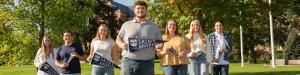 Saint Anselm students standing on the quad with mini class banners