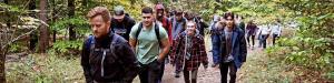 Students hiking through the woods