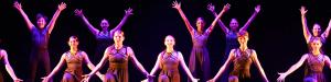 Students performing a dance routine on stage