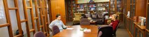 Two students sitting in the NHIOP political library