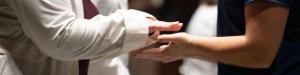 Two hands being blessed