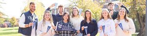 Students holding blue banners that say "Saint Anselm"