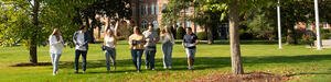 Students walking with banners on a college campus