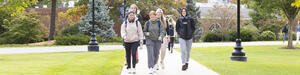 Students walking on a college campus in the fall