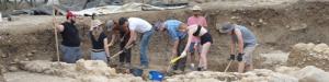 Students working at a dig site