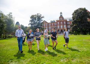family walks in front of alumni hall