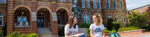 students chat on the steps in front of alumni hall