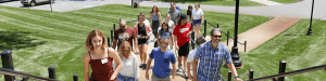 students walking up the steps from the lower quad