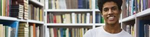 student stands in a library