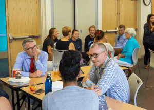  campus community gathering together to discuss that week's come friday forum question